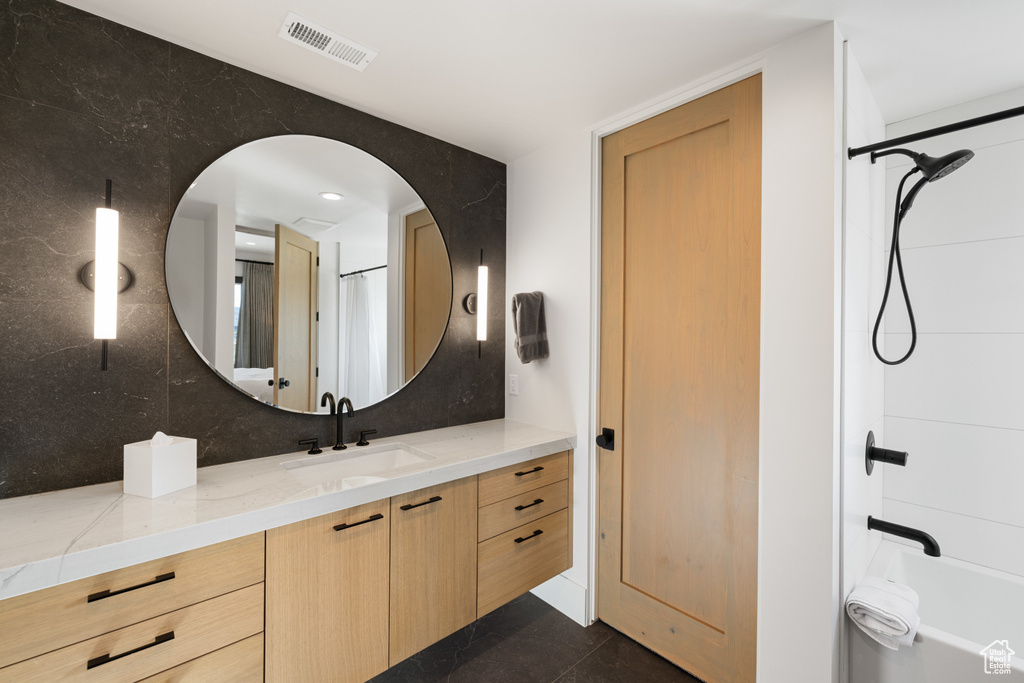 Bathroom with vanity, shower / tub combo with curtain, and tasteful backsplash