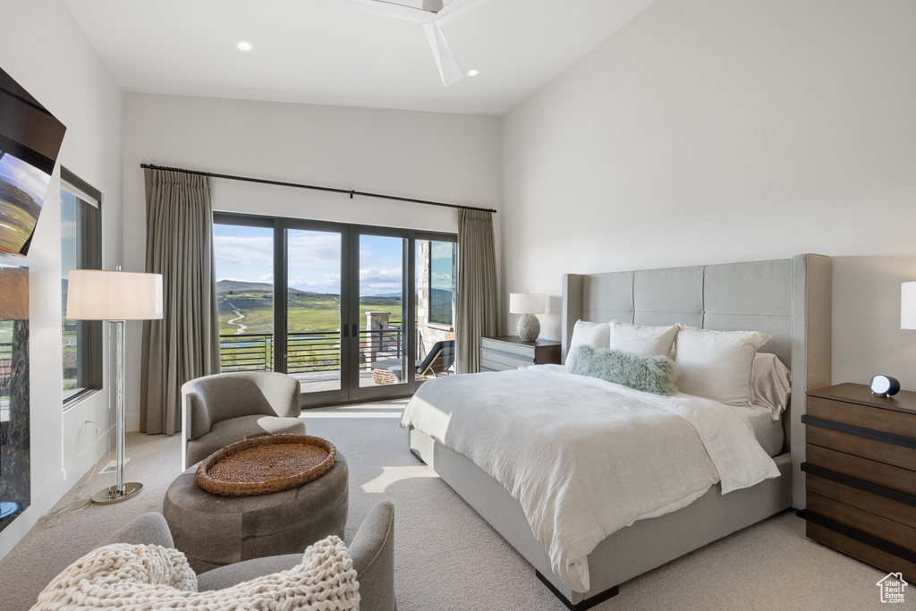 Bedroom with light carpet, access to exterior, high vaulted ceiling, and recessed lighting