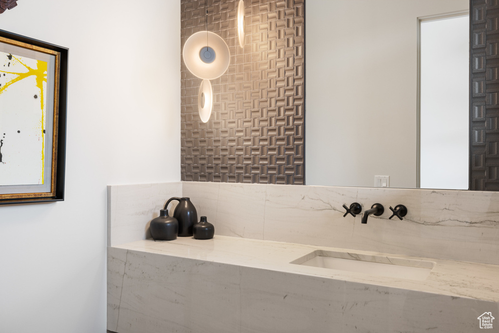 Bathroom featuring decorative backsplash and vanity