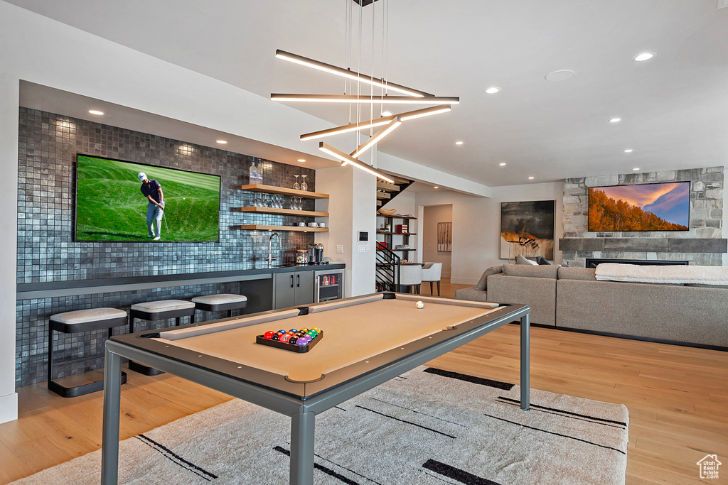 Playroom featuring wood finished floors, bar with sink, wine cooler, recessed lighting, and pool table