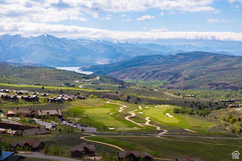 Aerial perspective of suburban area with a mountain backdrop and a golf course