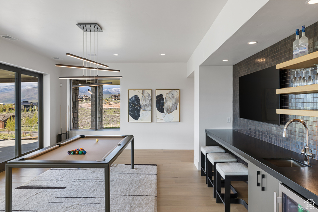 Recreation room with bar with sink, wine cooler, recessed lighting, light wood-style floors, and billiards