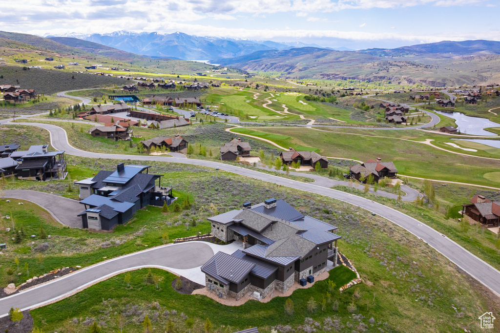 Aerial view of residential area featuring a water and mountain view and a golf club