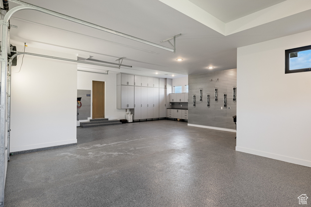 Garage featuring baseboards and recessed lighting