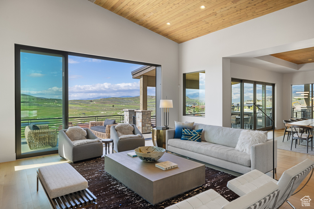 Living area with wood ceiling, recessed lighting, wood finished floors, and vaulted ceiling