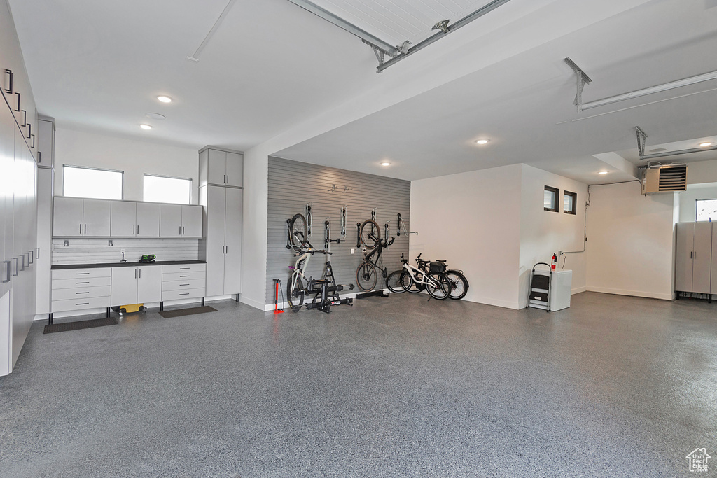 Garage with baseboards and recessed lighting