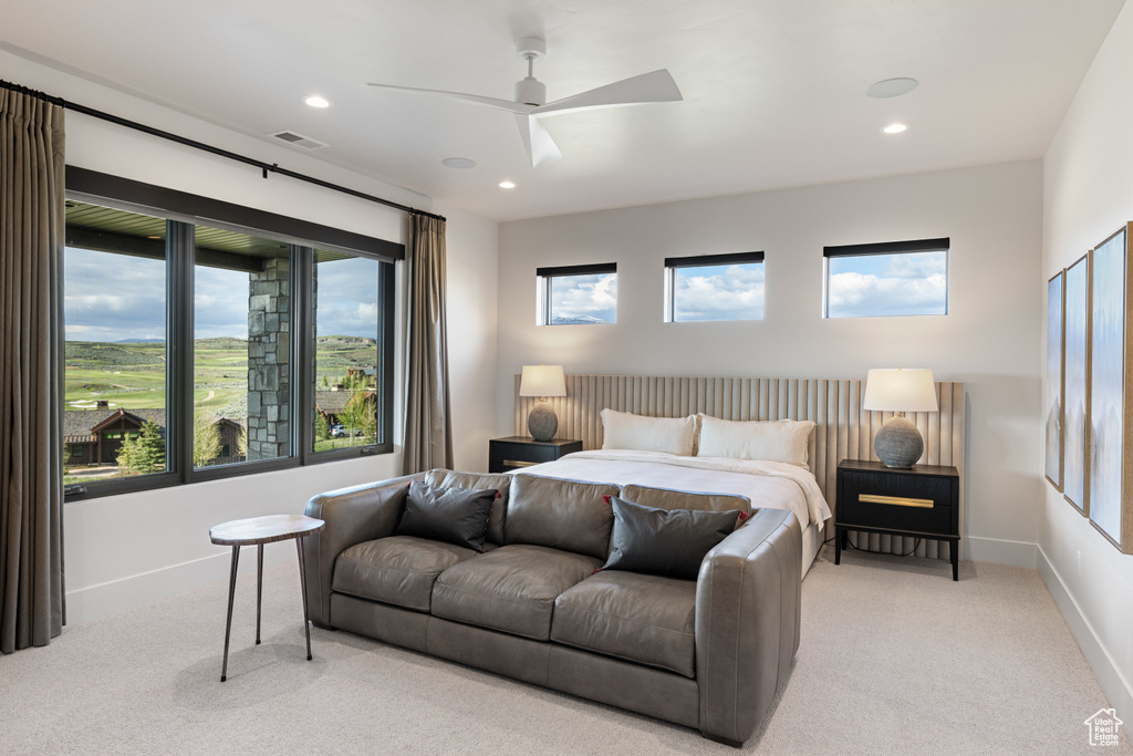 Bedroom with light carpet, recessed lighting, baseboards, and a ceiling fan