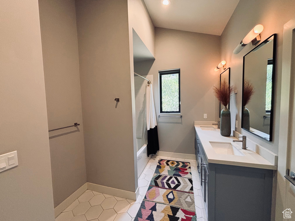 Full bath with double vanity, shower / bath combination with curtain, tile patterned floors, and recessed lighting