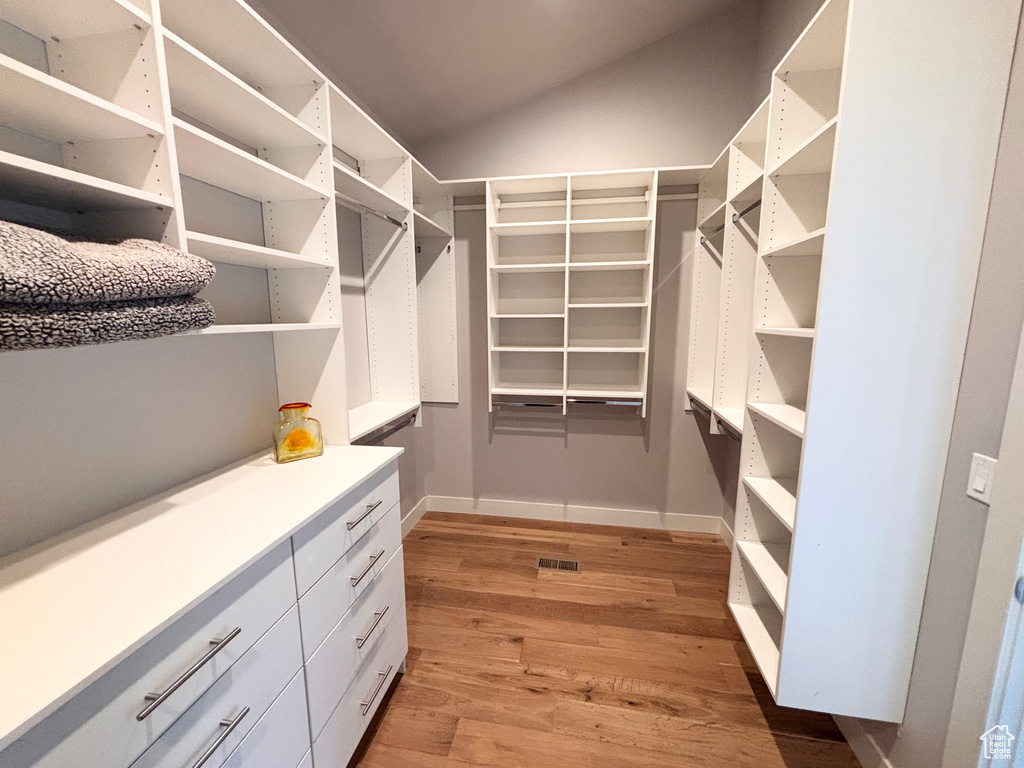 Walk in closet featuring light wood-style floors