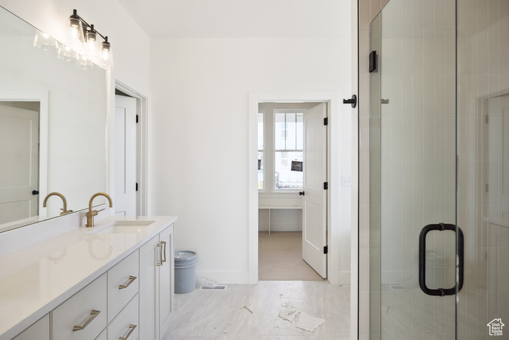 Bathroom featuring vanity and a shower stall