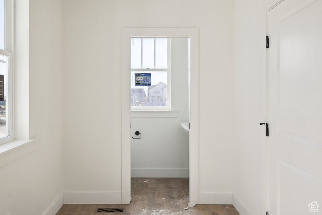 Laundry area with wood finished floors and baseboards