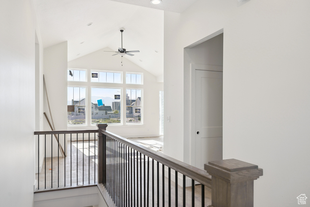 Hall featuring an upstairs landing and high vaulted ceiling