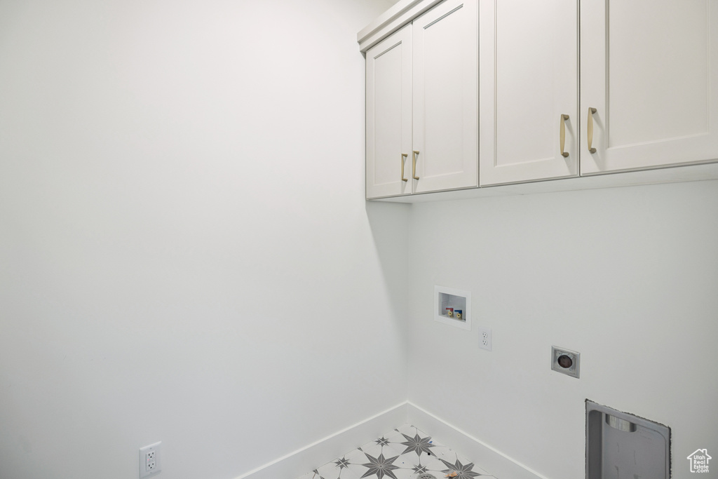 Washroom with cabinet space, washer hookup, and hookup for an electric dryer