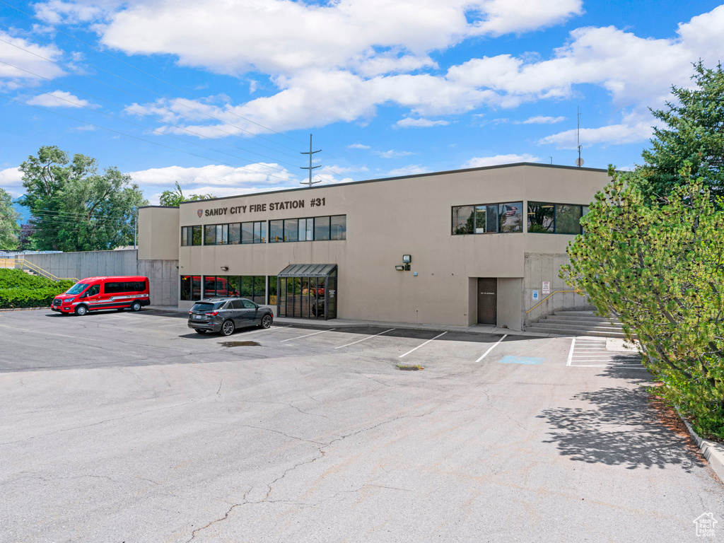 View of property with uncovered parking
