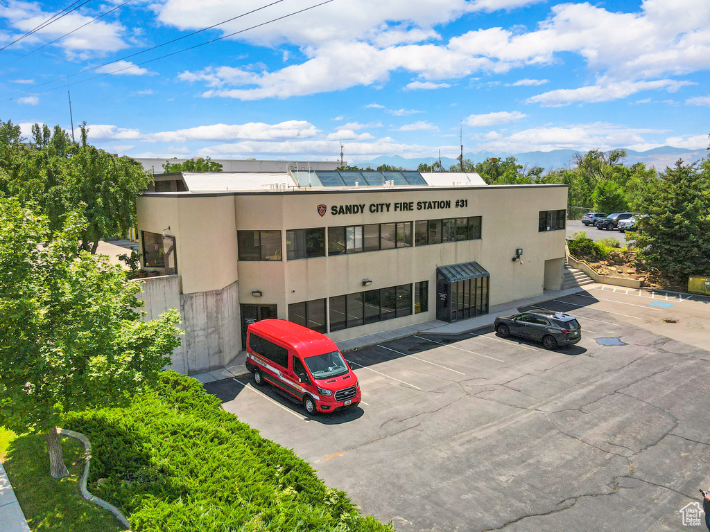 View of building exterior featuring uncovered parking