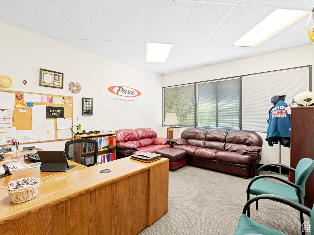Office area featuring carpet and a paneled ceiling