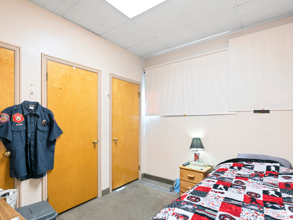 Bedroom featuring baseboards and a paneled ceiling