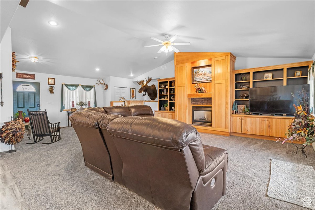 Carpeted living area featuring ceiling fan, vaulted ceiling, and recessed lighting