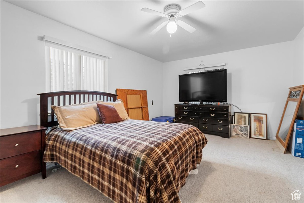 Bedroom featuring a ceiling fan and carpet