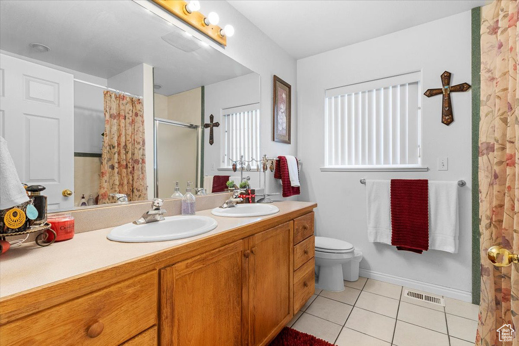 Bathroom with visible vents, tile patterned flooring, a sink, and a shower with shower curtain