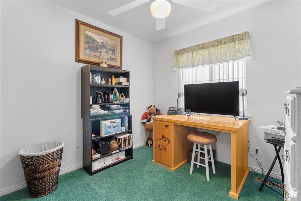 Office area featuring baseboards, carpet, and a ceiling fan
