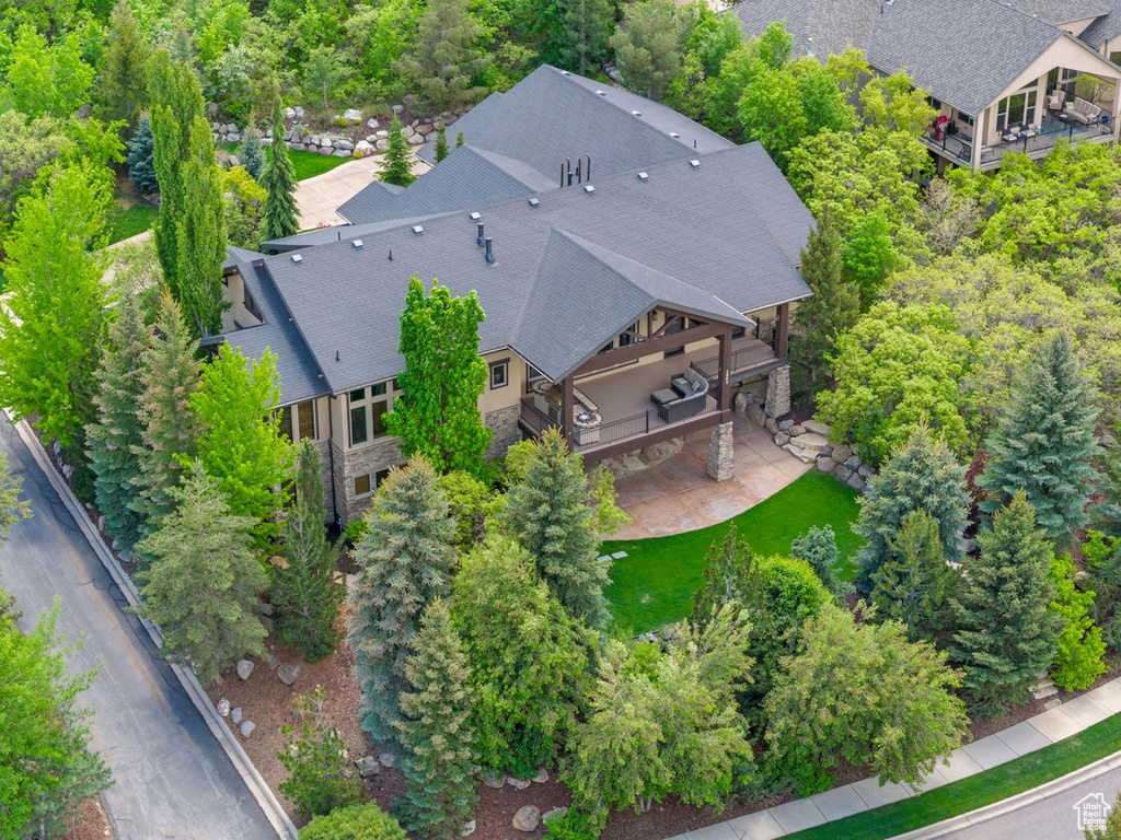 View from above of property featuring a tree filled landscape