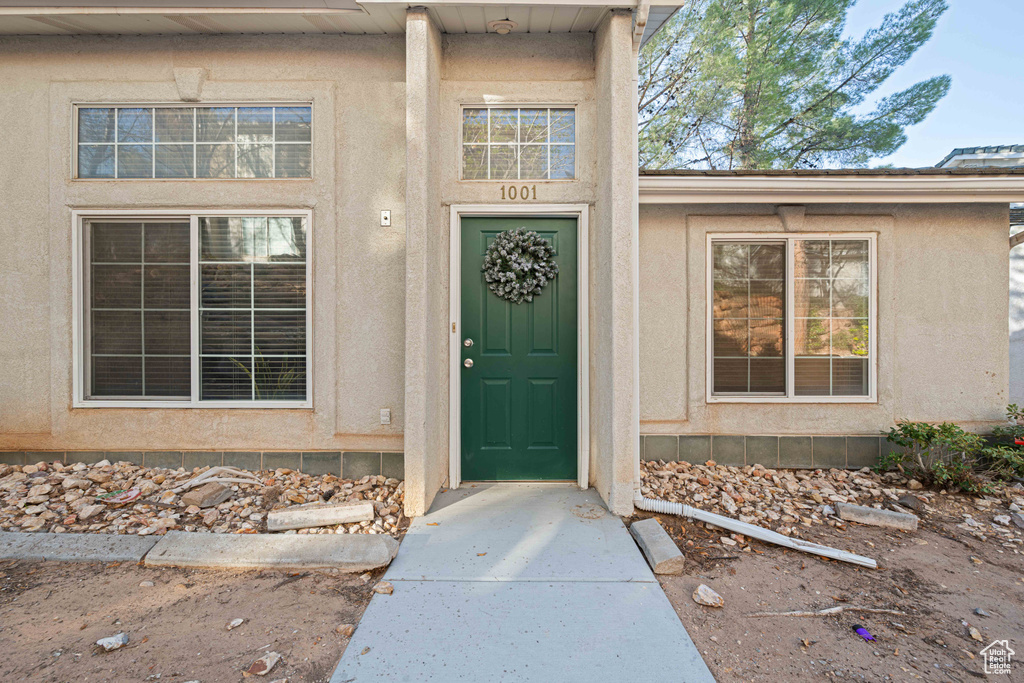 Property entrance featuring stucco siding