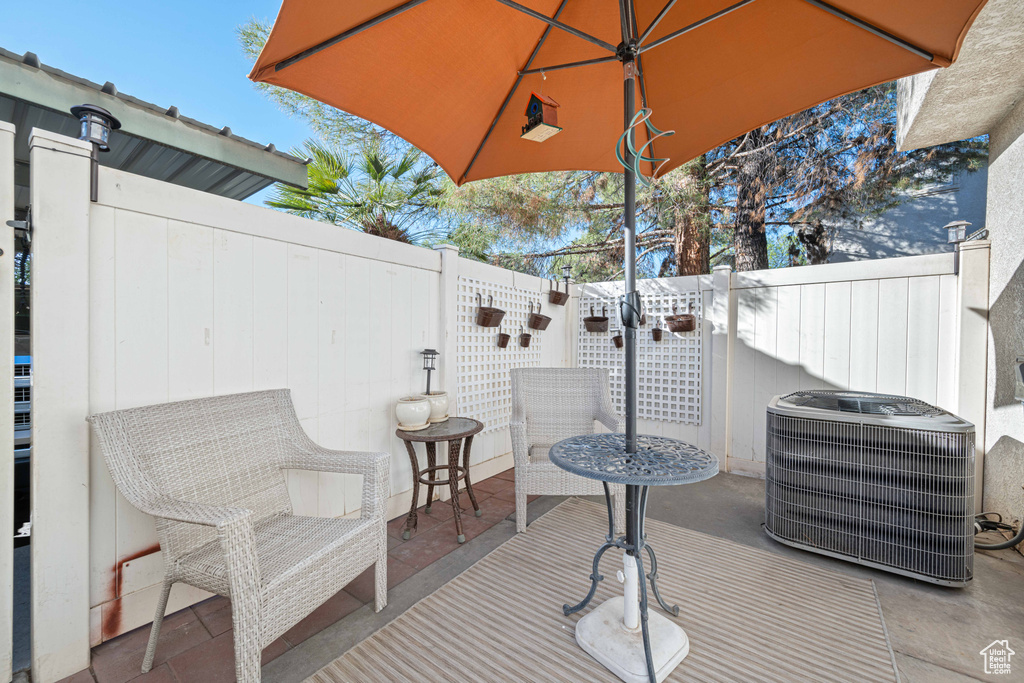 View of patio featuring fence and central AC