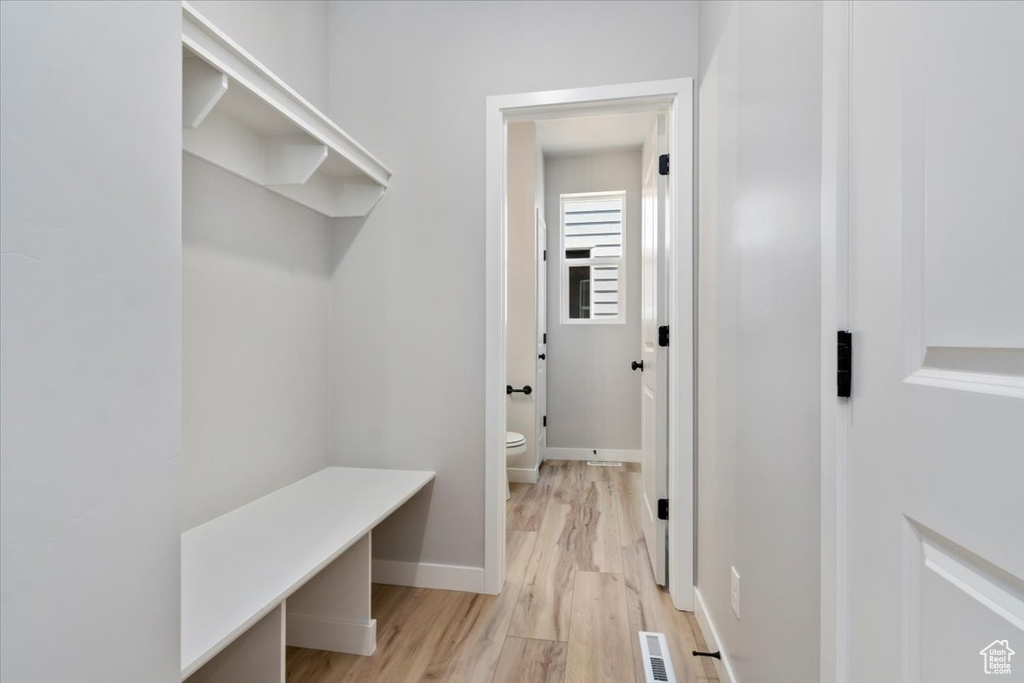 Mudroom featuring light wood-type flooring, baseboards, and visible vents
