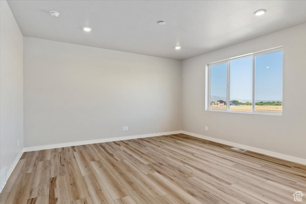 Spare room with baseboards, visible vents, recessed lighting, and light wood-type flooring
