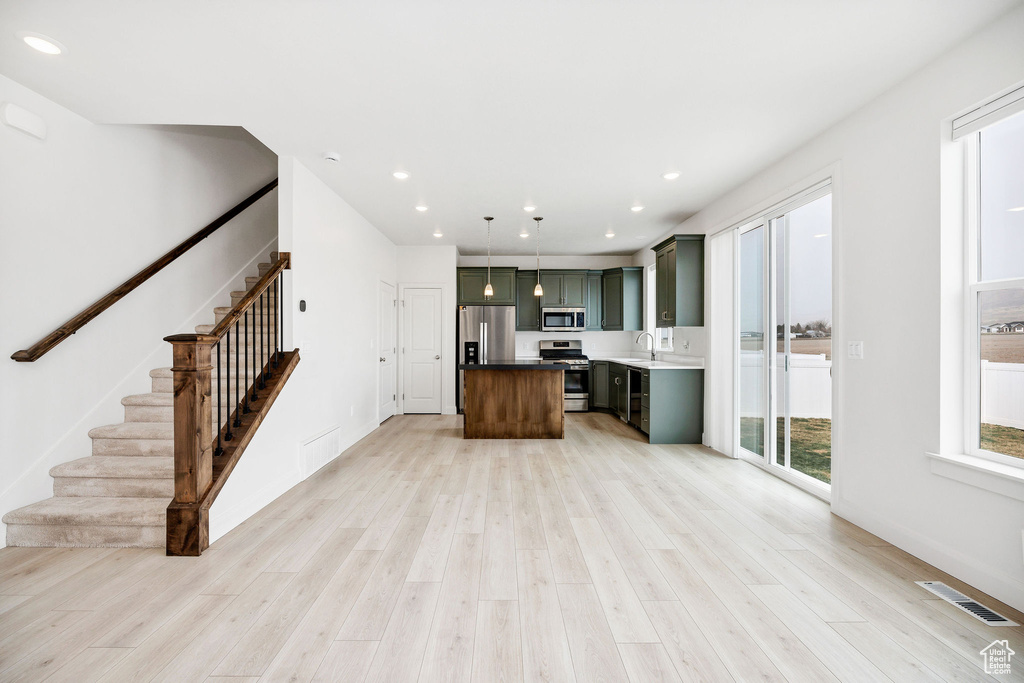 Kitchen featuring recessed lighting, stainless steel appliances, light wood finished floors, and visible vents
