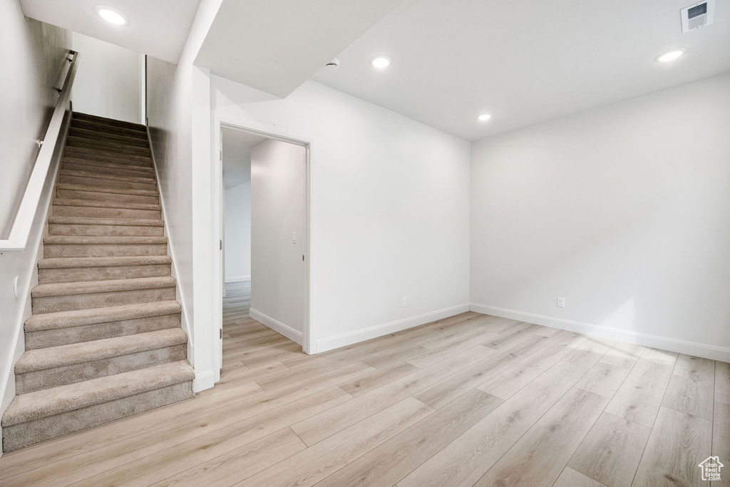 Interior space with visible vents, light wood finished floors, baseboards, recessed lighting, and stairway