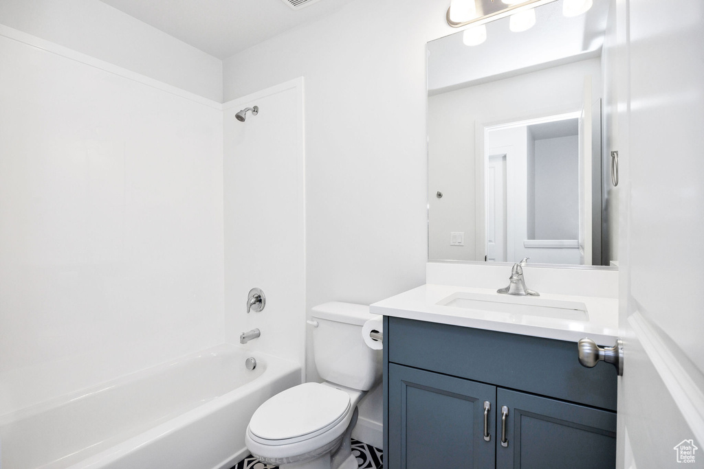 Bathroom with shower / tub combination, visible vents, toilet, and vanity