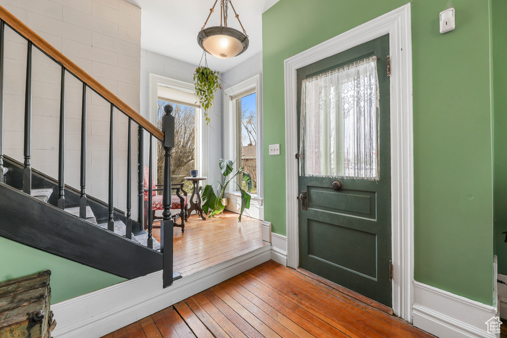 Entrance foyer featuring hardwood / wood-style flooring, baseboards, and stairs