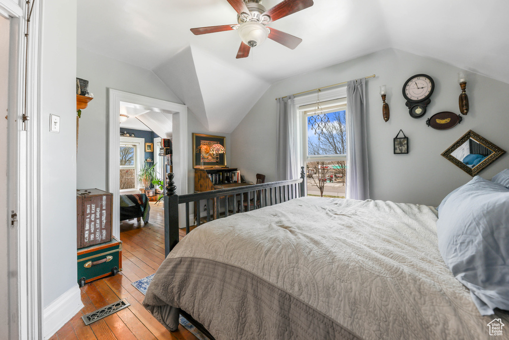 Bedroom featuring a ceiling fan, hardwood / wood-style flooring, and lofted ceiling