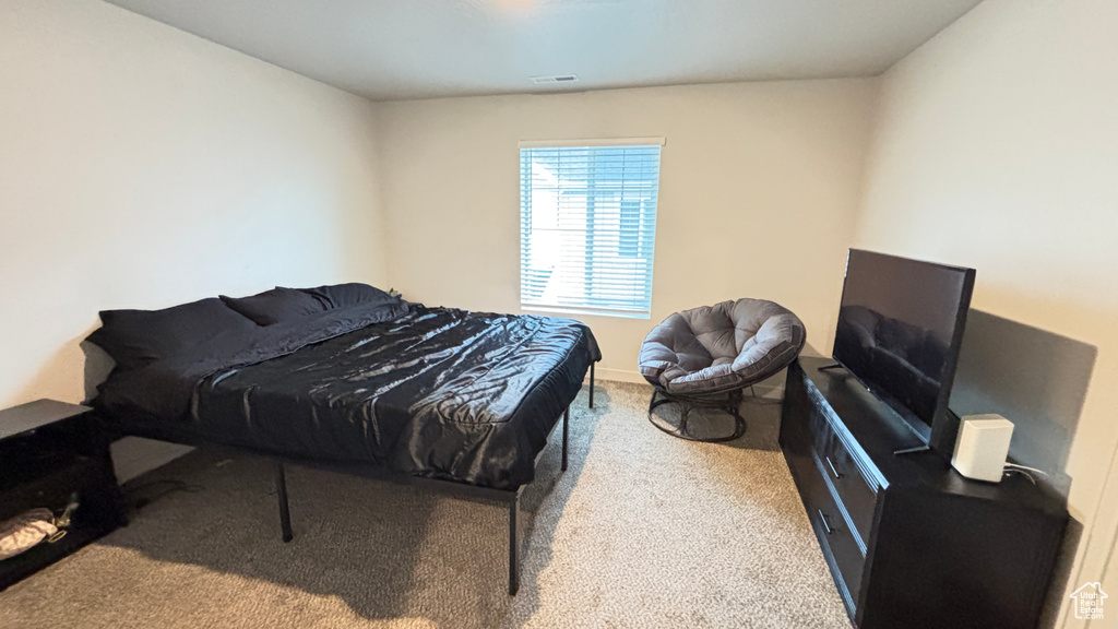 Bedroom with carpet flooring and visible vents