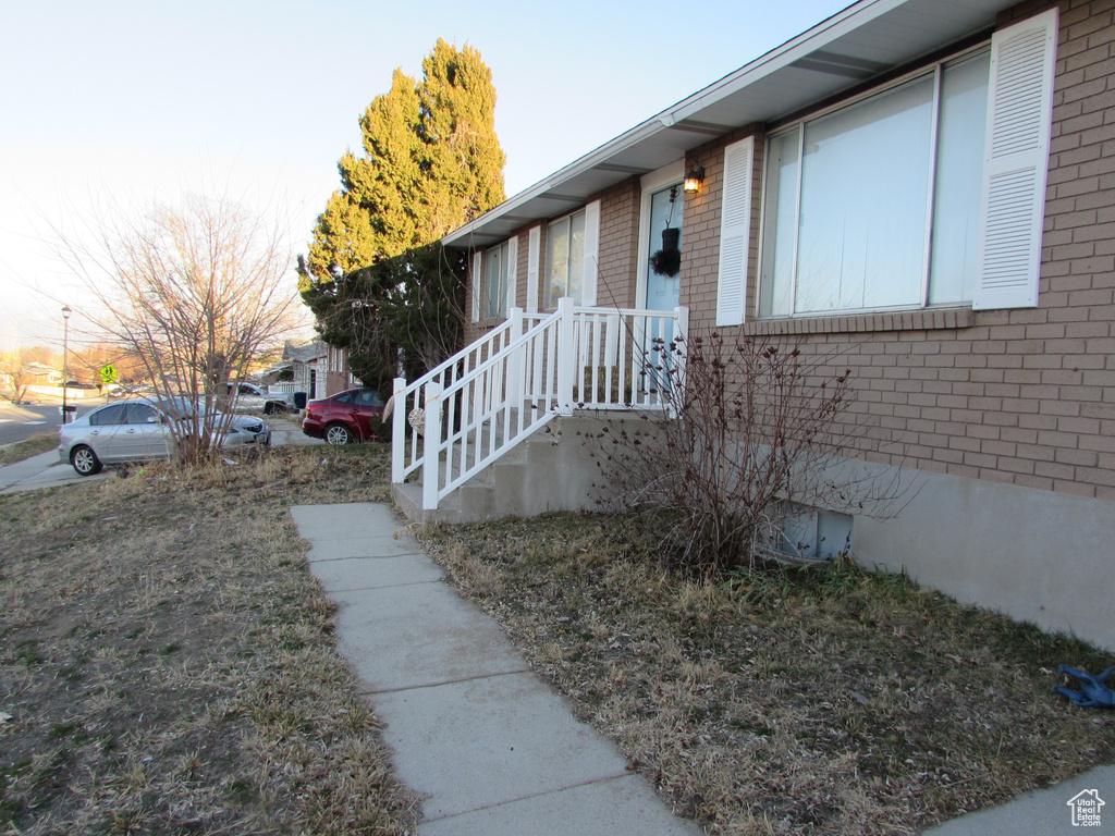 View of property exterior with brick siding