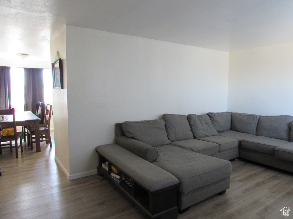 Living room with light wood-type flooring and baseboards