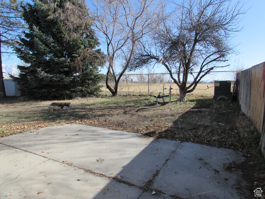 View of yard with a patio and fence