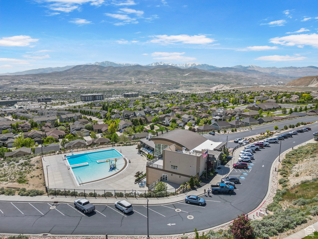 Drone / aerial view of a mountainous background and a pool