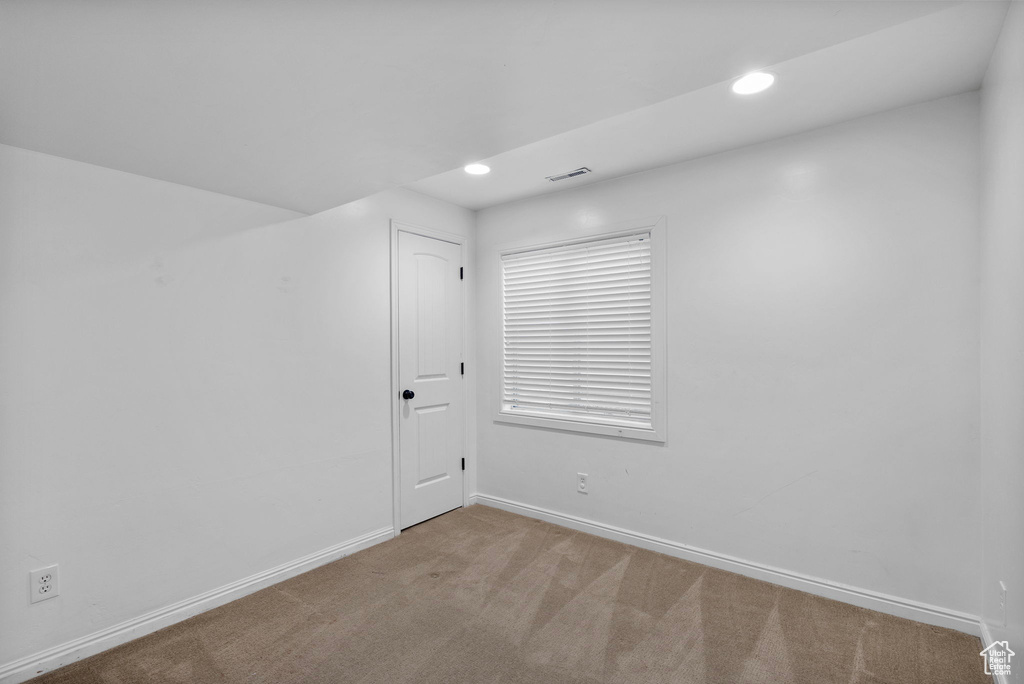 Empty room featuring baseboards, carpet, and recessed lighting