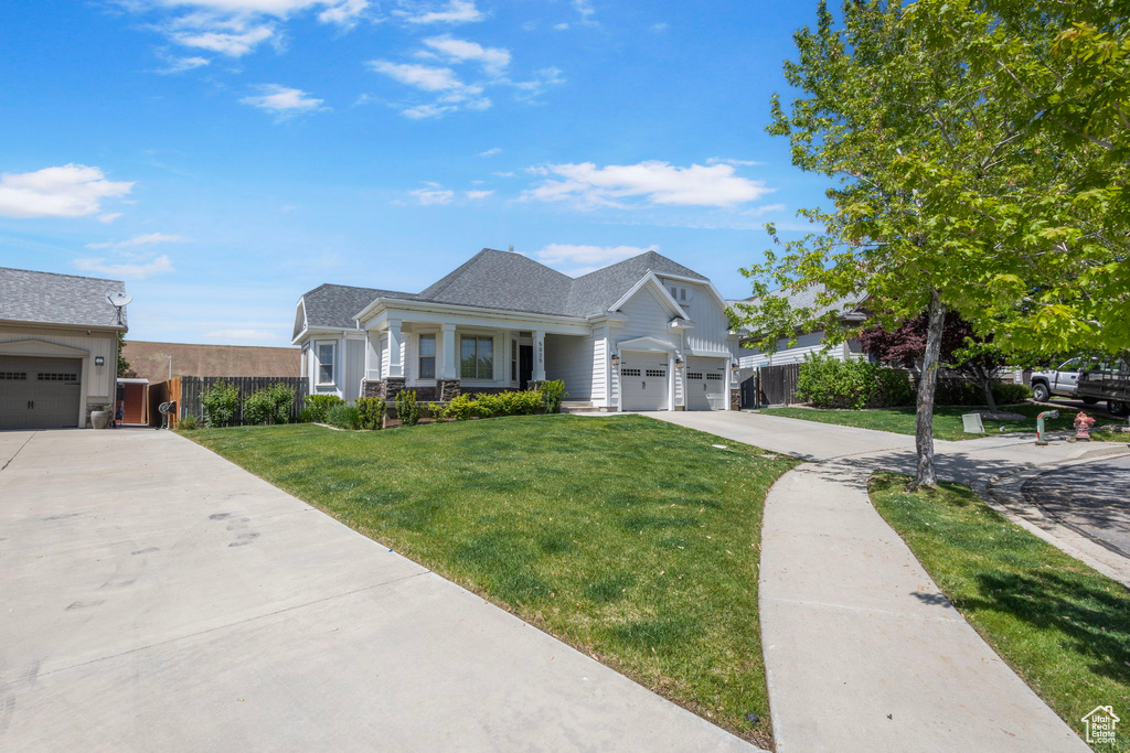 Traditional-style home with concrete driveway, a porch, a garage, and roof with shingles