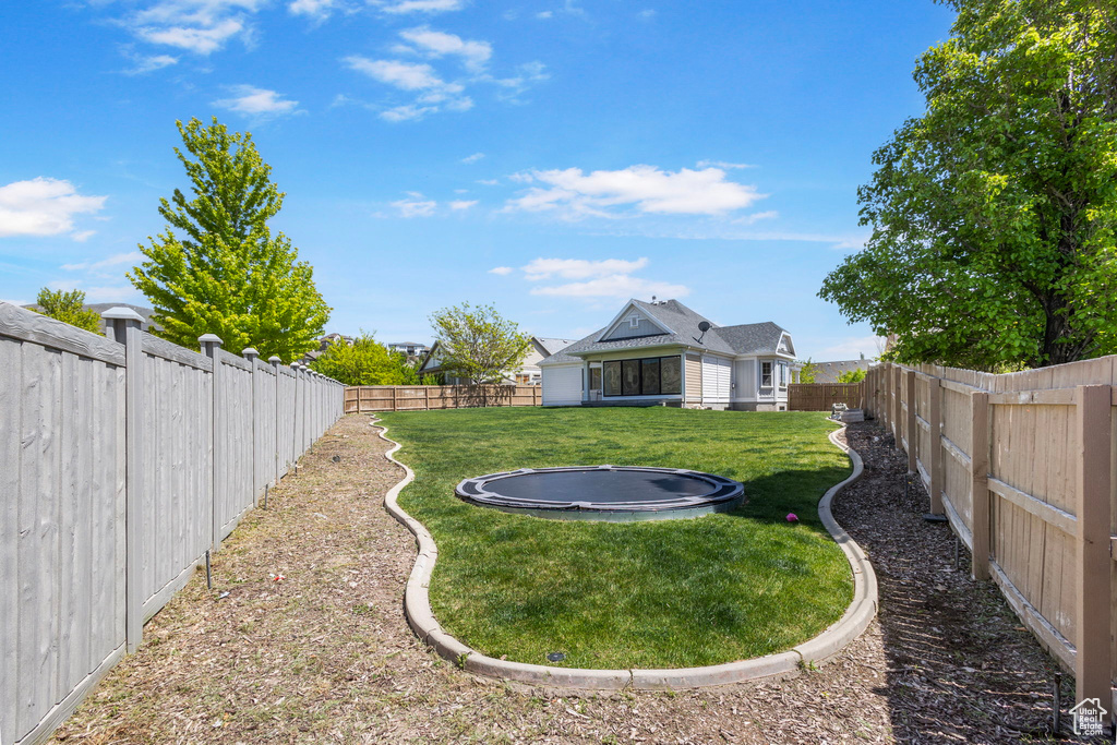 View of yard with a trampoline