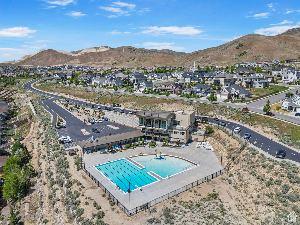 Aerial perspective of suburban area featuring a pool area and mountains