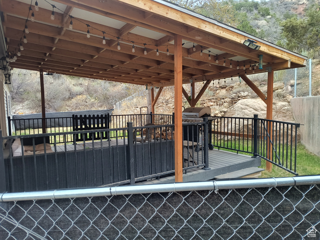 Wooden deck with a carport and grilling area