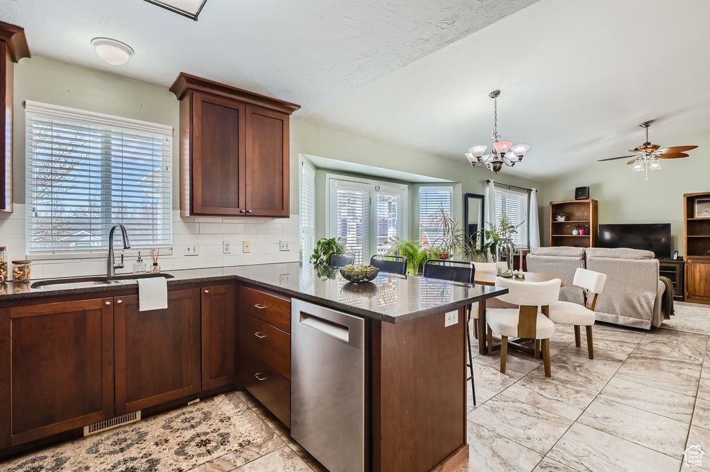 Kitchen featuring marble finish floor, tasteful backsplash, a sink, ceiling fan with notable chandelier, and stainless steel dishwasher