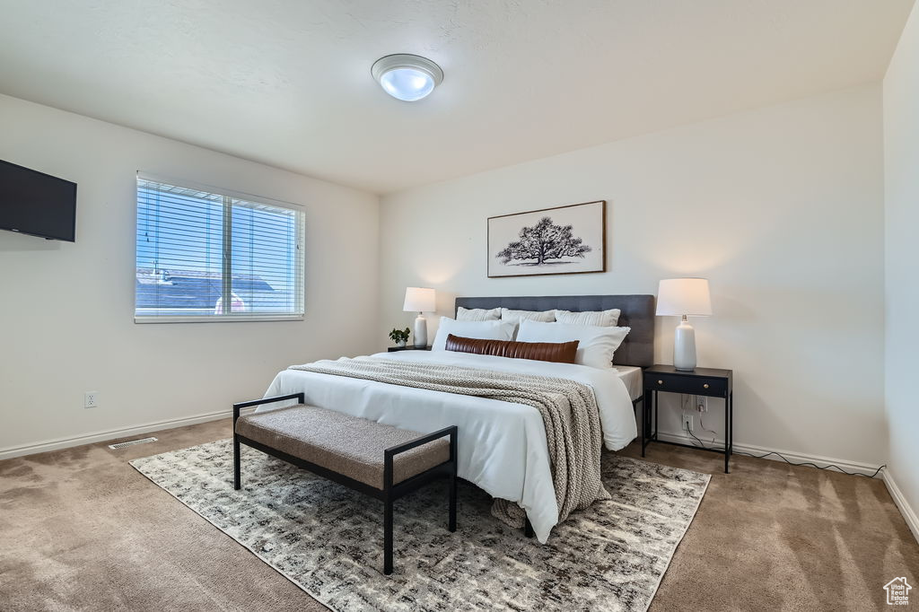 Bedroom featuring carpet, baseboards, and visible vents