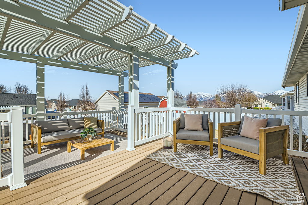 Deck featuring a pergola and an outdoor hangout area