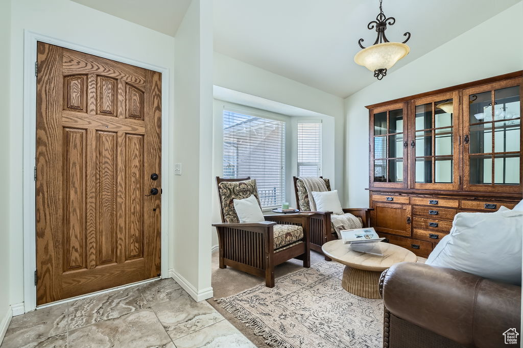 Entryway featuring baseboards and vaulted ceiling
