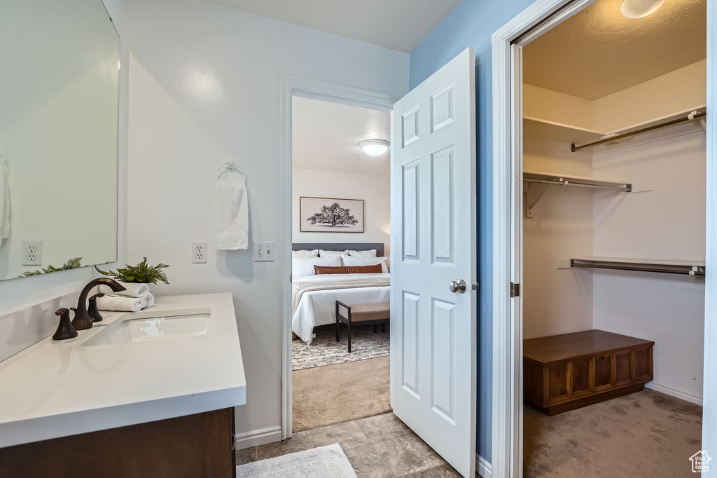 Ensuite bathroom featuring connected bathroom and vanity